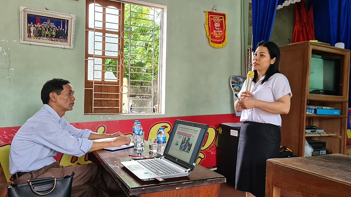 Ông Mai Xuân Ái, Phó Chủ tịch UBND xã Quyết Tiến, đại diện chính quyền địa phương (ngồi) và bà Nguyễn Thị Loan, Phó Giám đốc BHXH huyện Tiên Lãng đang tuyên truyền về chính sách BHXH tự nguyện tại thôn Phú Cơ.