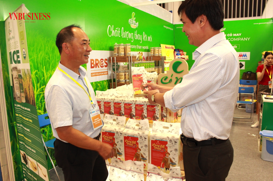 Gạo chất lượng cao của Việt Nam được đối tác thu mua của Trung Quốc &lpar;đứng bên trái&rpar; rất quan tâm và đặt nhiều đơn hàng.