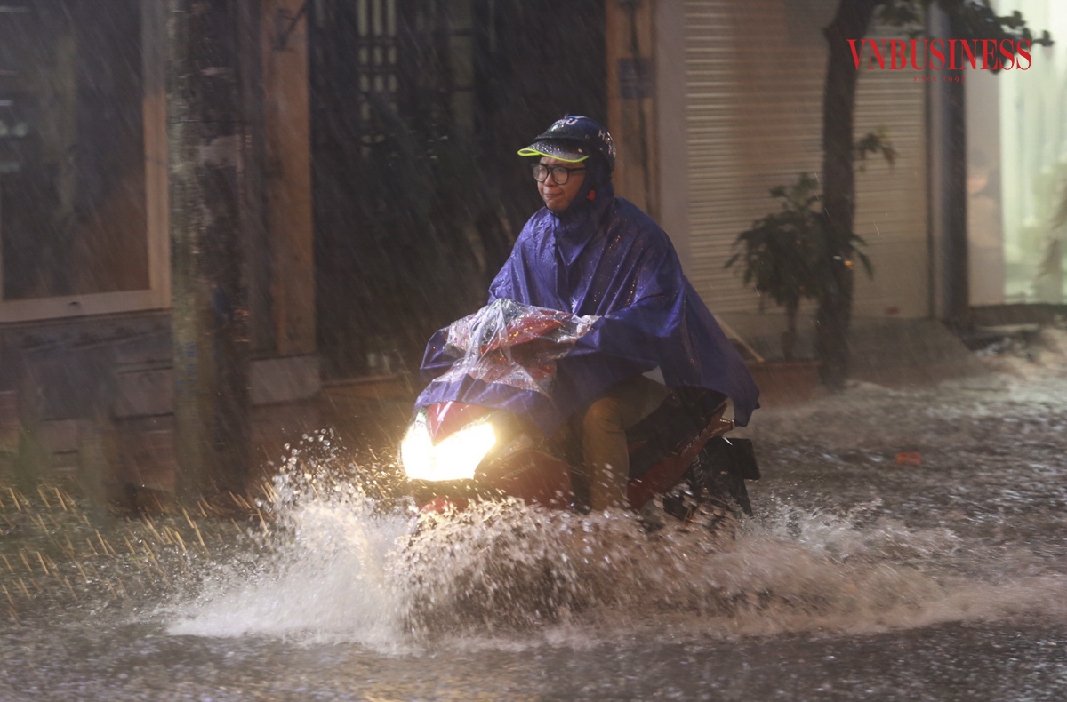 Nhiều phương tiện phải rẽ sóng vượt qua biển nước để trở về nhà.