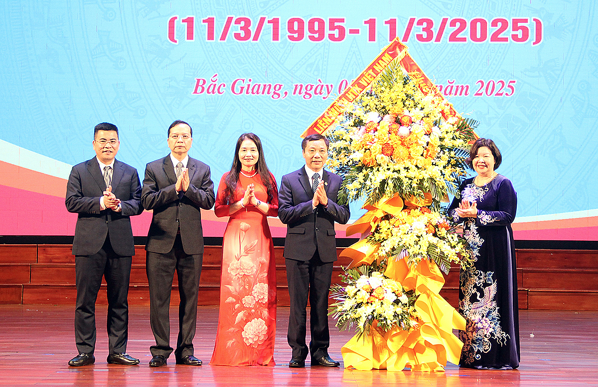 Chủ tịch Liên minh HTX Việt Nam Cao Xuân Thu Vân tặng hoa chúc mừng Liên minh HTX tỉnh.